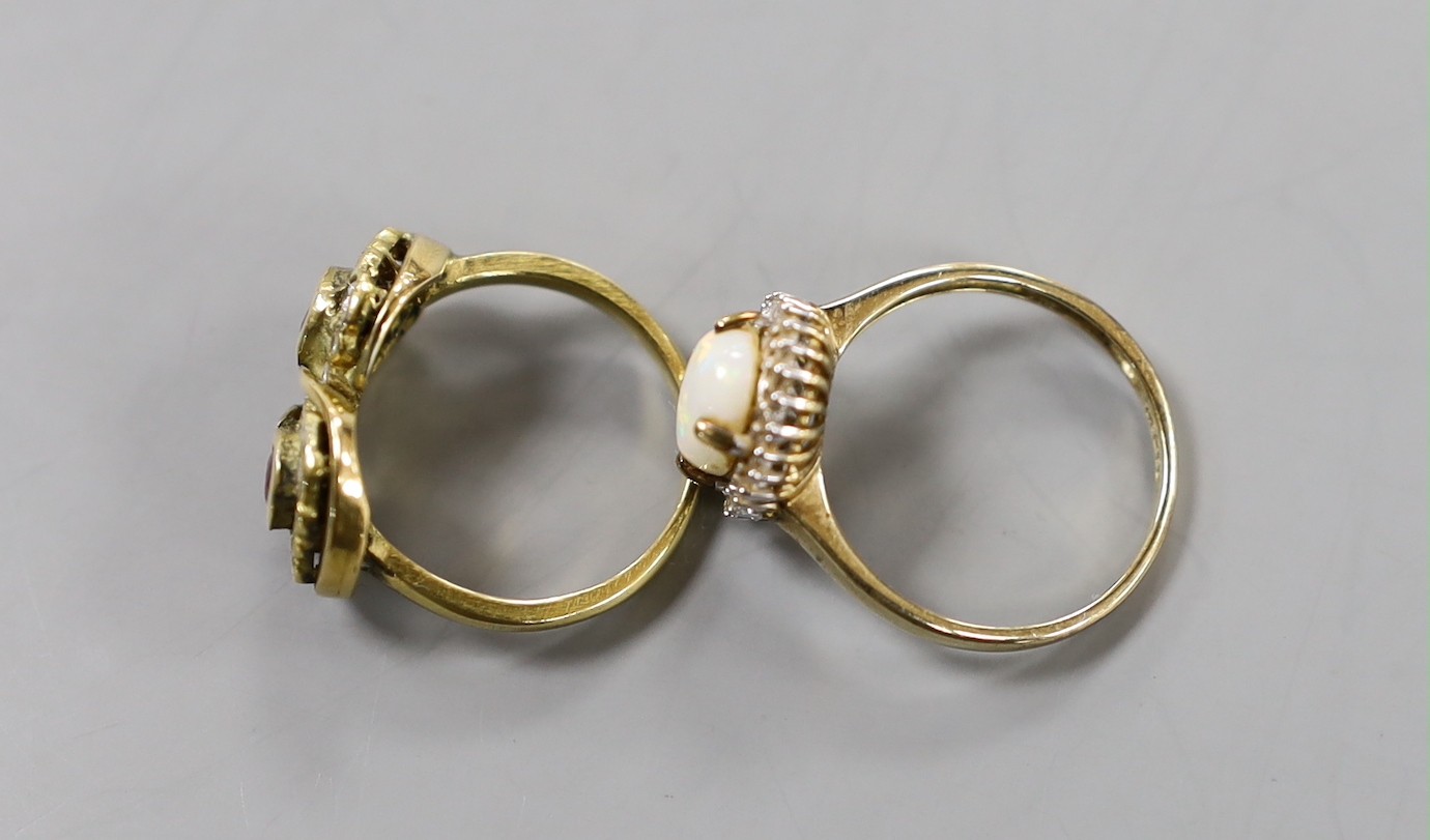 A modern yellow metal ruby? and diamond set double cluster ring, size N, gross weight 6.3 grams and a modern 9ct gold, white opal and diamond chip set oval cluster ring, gross weight 2.3 grams.